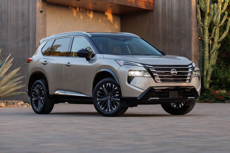 Silver Nissan SUV parked on a concrete surface with modern architectural elements in the background